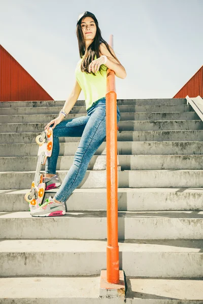 Girl on stairs with skateboard. — Stock Photo, Image