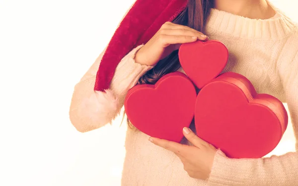 Girl holds heart shaped gift boxes — Stock Photo, Image