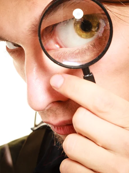 Man looking through magnifying glass. — Stock Photo, Image