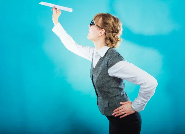 Business woman holding airplane