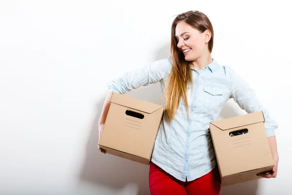 Happy woman moving into house carrying boxes. — Stock Photo, Image