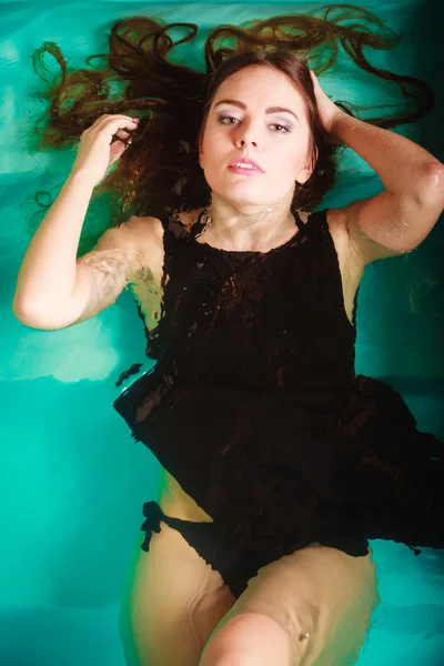 Sexy seductive woman in black dress in water. — Stock Photo, Image