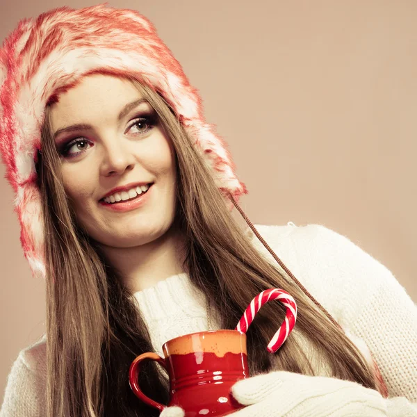 Christmas girl with mug and cane. — Stock Photo, Image