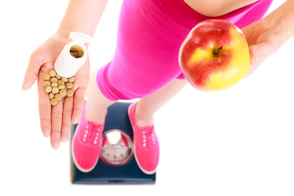 Frau mit Vitaminen und Apfel. Gesundheitsversorgung. — Stockfoto