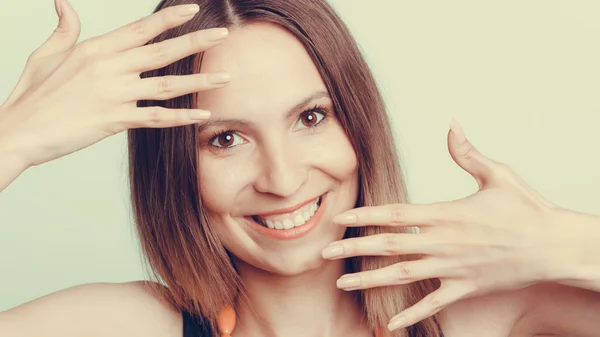 Attractive happy woman showing hands palms. — Stockfoto
