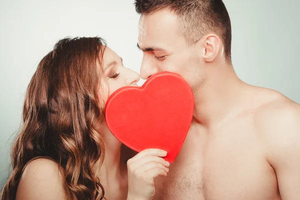 Loving couple kissing behind red heart. Love. — Stock Photo, Image