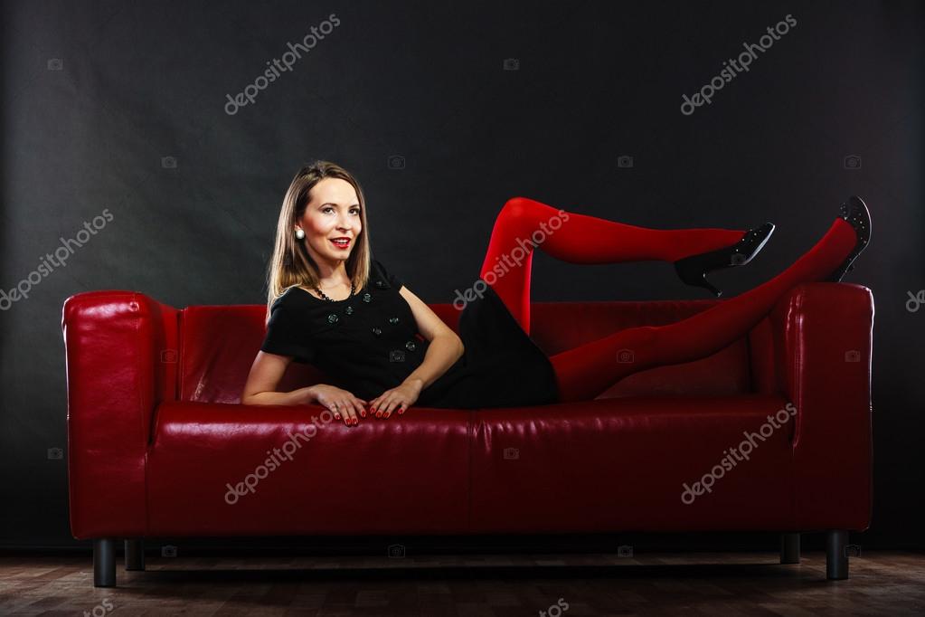 Fashion woman in red pantyhose on couch - Stock Photo [72617681
