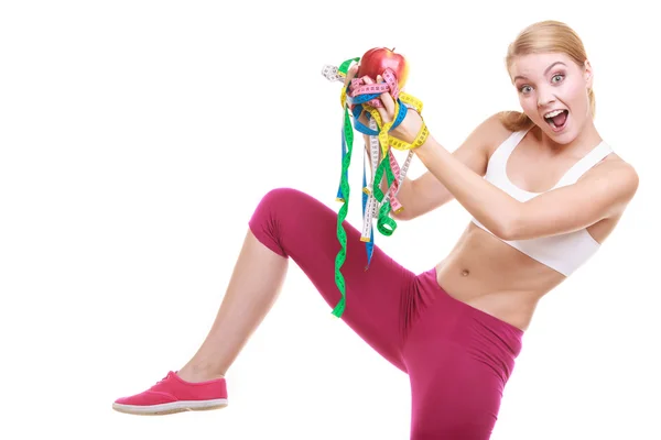 Woman holding apple and tapes — Stock Photo, Image