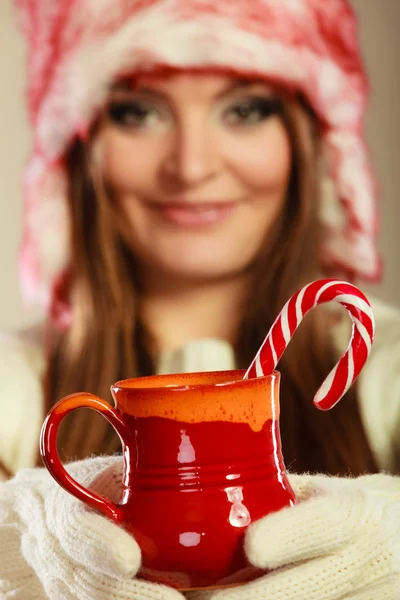 Christmas girl with mug and cane. — Stock Photo, Image