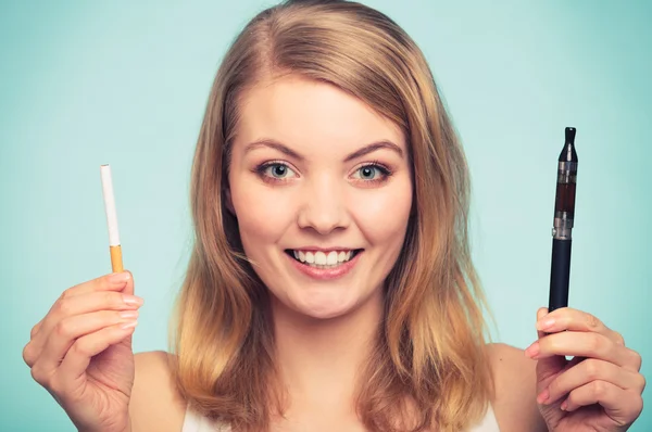 Girl with normal and electronic cigarette. — Stock Photo, Image