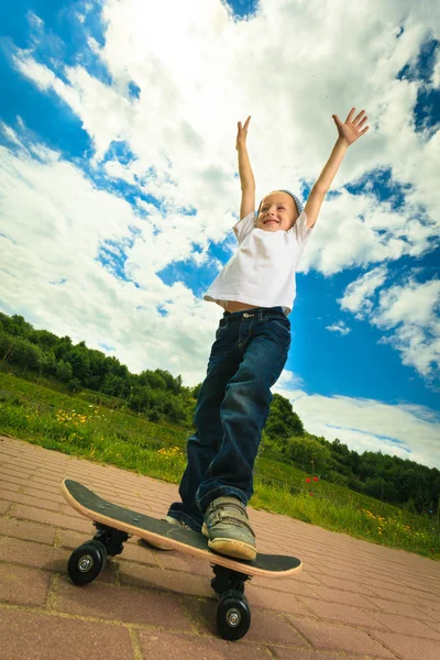 Skater pojke barn med sin skateboard. Friluftsliv. — Stockfoto