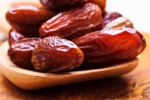 Dried dates on wooden spoon — Stock Photo, Image