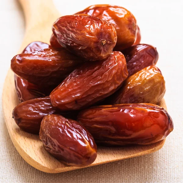 Dried dates on wooden spoon — Stock Photo, Image