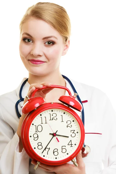 Doctor with big red alarm clock — Stok fotoğraf