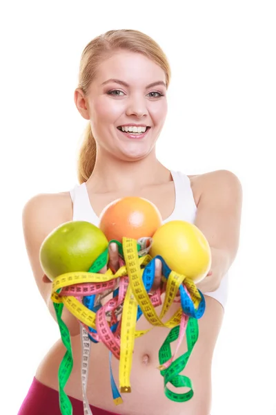 Woman  holding grapefruits and tapes — Stock Photo, Image