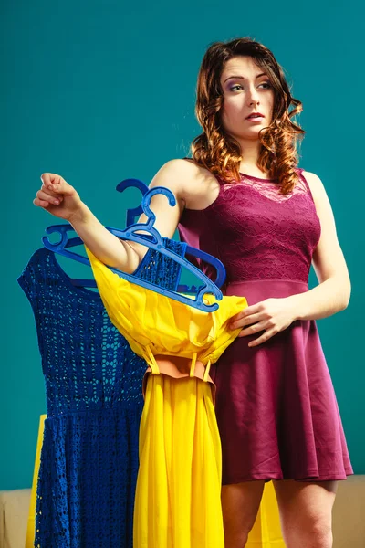 Woman customer holding hangers — Stock Photo, Image