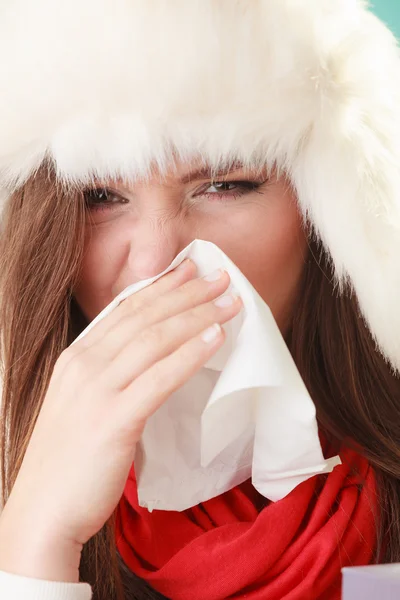 Woman in fur hat sneezing — Stock Photo, Image