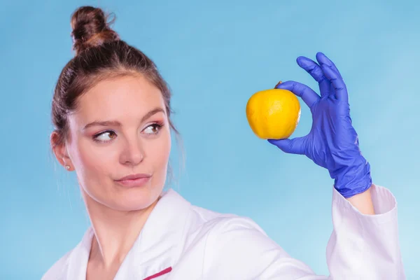 Chemist holding  fruit. — Stock Photo, Image