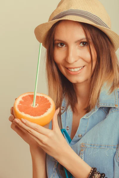 Mulher de chapéu segurando toranja — Fotografia de Stock