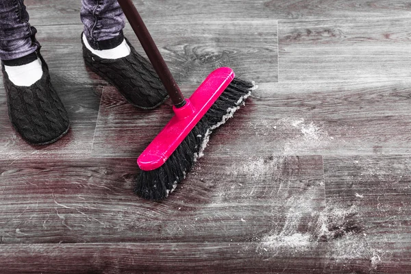 Broom and female feet — Stock Photo, Image