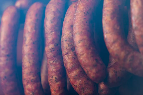 Traditional food. Smoked sausuages in smokehouse. — Stock Photo, Image