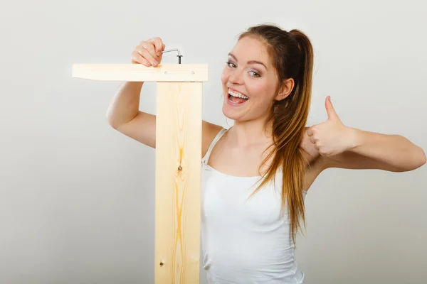 Success ful woman assembling furniture. DIY. — 图库照片