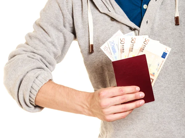 Tourist holding passport full of money. — Stock Photo, Image