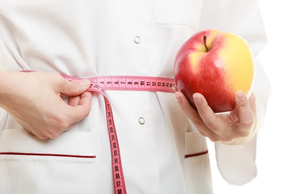 Doctor specialist holding fruit apple measuring waist — Stock Photo, Image