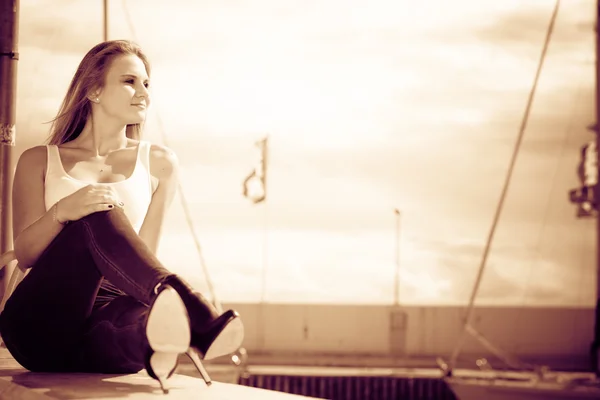 Vrouw zittend op marina — Stockfoto