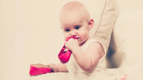 Baby girl biting shoe — Stock Photo, Image