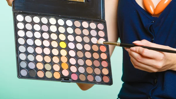 Femme tient la palette colorée professionnelle de maquillage — Photo