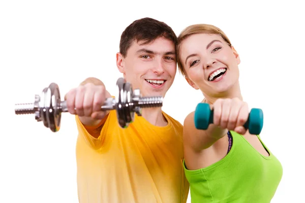 Couple exercising with dumbbells lifting weights — Stock Photo, Image