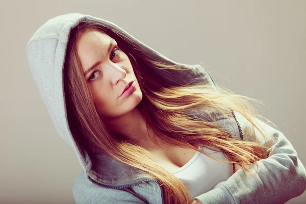 Pensive teenager girl in hood crossing arms. — Stock Photo, Image