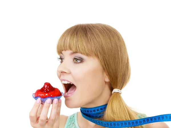 Donna tiene cupcake cercando di resistere alla tentazione — Foto Stock