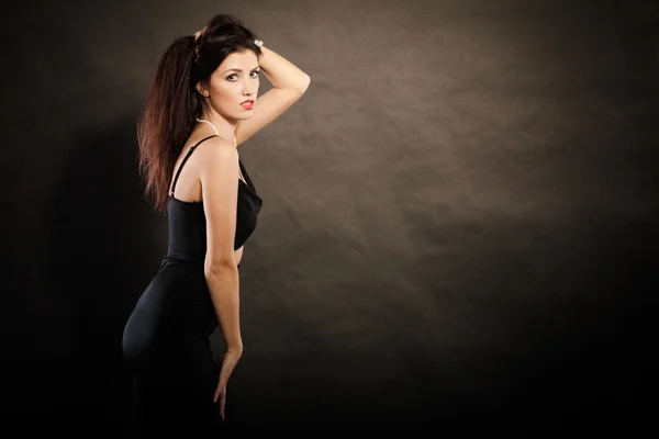 Woman in sensual black dress on dark — Stock Photo, Image