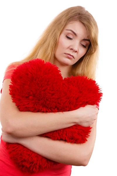 Woman  hugging red heart pillow — Stock Photo, Image