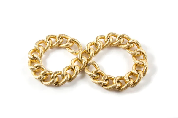 Golden chain of twisted rings. Isolated on white — Stock Photo, Image