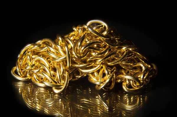 Golden chain of twisted rings. Isolated on white — Stock Photo, Image
