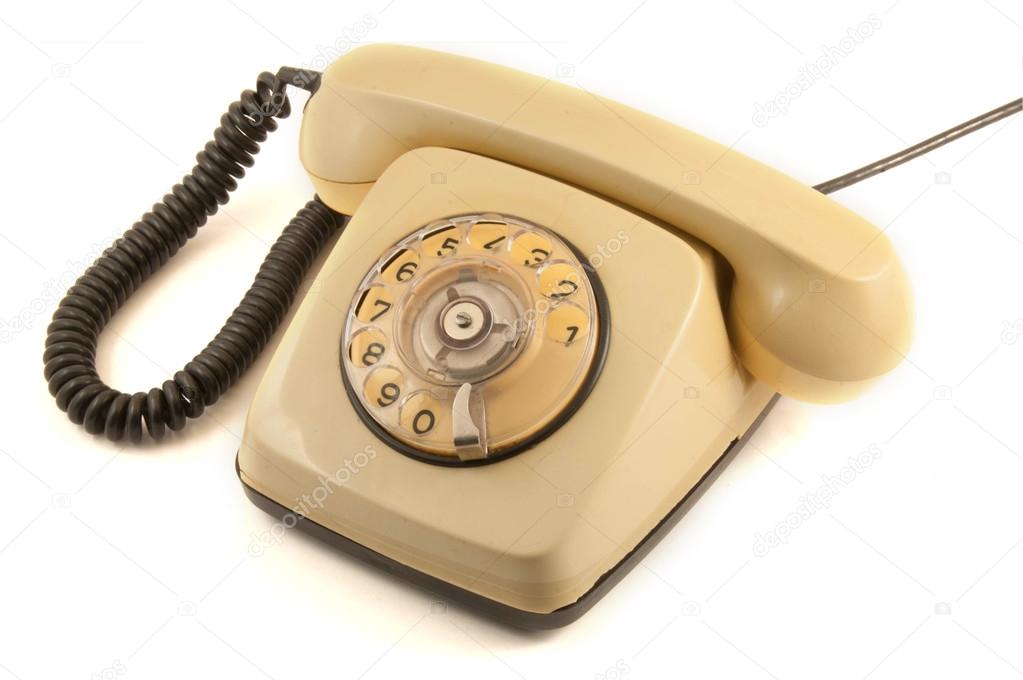 Vintage beige telephone isolated over white background