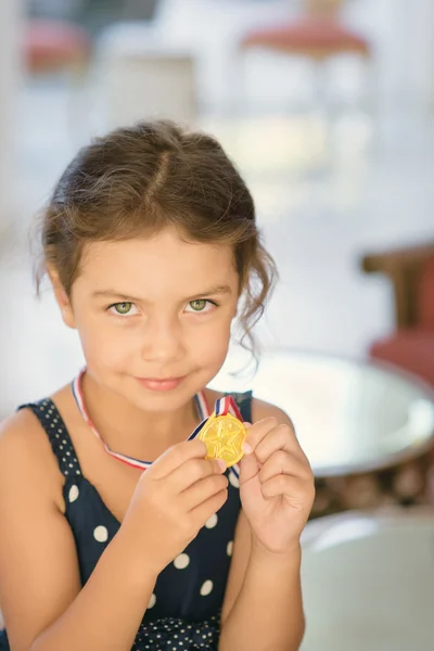 Little girl with medal — Stock Photo, Image