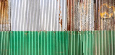 Old rusty zinc sheet wall, rusty zinc barn wall. Panorama zinc wall pattern texture background