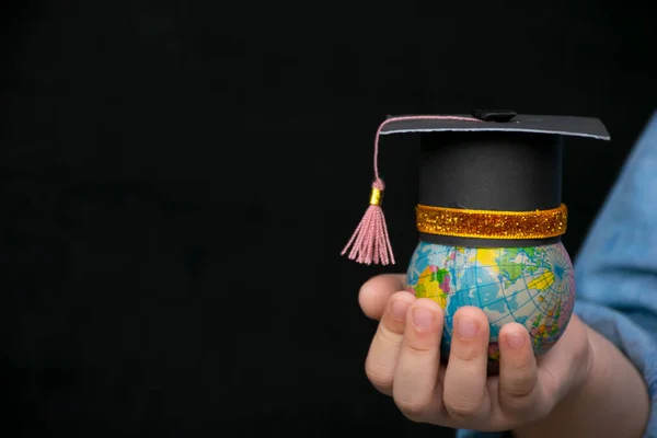 Education in Global world, Graduation cap on the girl\'s hand holding Earth globe model map with Radar background in hands. Concept of global business study, abroad educational, Back to School