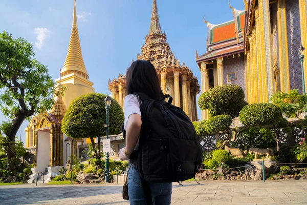 Asian tourist women travel in old Thai buddhist temple outdoor, in Wat phra kaew and grand palace travel in Bangkok city, Thailand