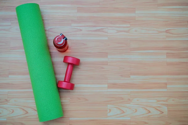Online home training sports or yoga class concept, Top view yoga mat on the wood floor.
