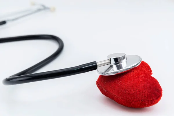 Stethoscope and red heart Heart Check, white isolated background. Healthcare concept