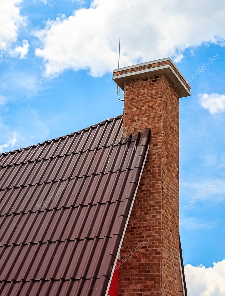 Chimney on the Tile Roof against Sky Background
