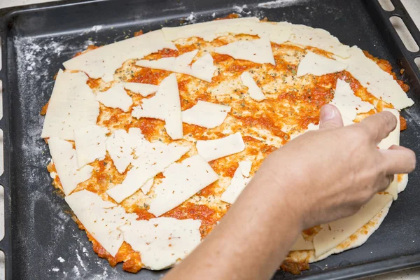 Preparing the pizza dough with cheese — Stock Photo, Image