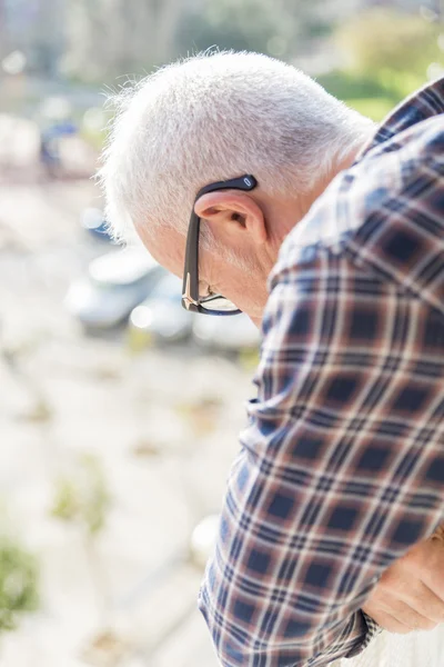 Adult man looking out the balcony — Stock Photo, Image