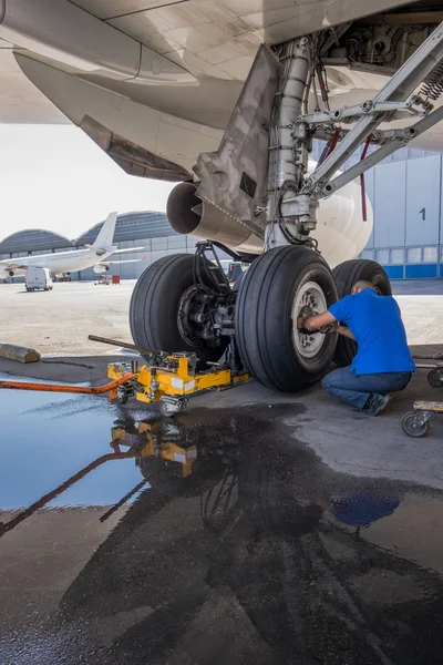 Engineer repairing aircraft landing gear