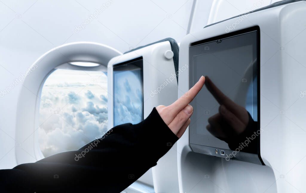 Detail of airplane interior with the touch screen monitor in-flight entertainment